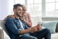 Happy middle-eastern couple using mobile phone at home Royalty Free Stock Photo