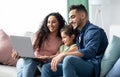 Happy Middle Eastern Family Of Three Using Laptop Together At Home Royalty Free Stock Photo