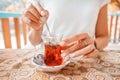 Woman drinks traditional Turkish tea on the veranda or terrace of an outdoor restaurant Royalty Free Stock Photo