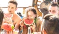 Happy millenial friends having fun at sail boat party with watermelon sangria and champagne - Cool friendship concept