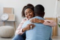 Happy millennial african american woman holding house keys, hugging boyfriend in their new apartment Royalty Free Stock Photo