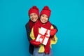 Happy millennial asian guy in hat show box present and hugs woman