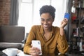 Happy millennial Black girl enjoying online shopping, using ecommerce app Royalty Free Stock Photo