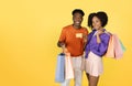 Happy millennial black guy and lady with many bags show credit card, recommend shopping Royalty Free Stock Photo