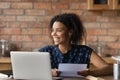 Happy millennial Black student girl receiving paper letter, invitation