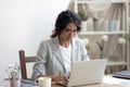 Happy millennial businesswoman negotiating with client supplier by email messenger