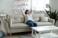 Happy young woman relax on couch at home Royalty Free Stock Photo