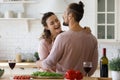 Happy millennial couple dancing in kitchen. Royalty Free Stock Photo