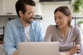 Happy millennial couple have fun using laptop at home Royalty Free Stock Photo