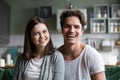 Happy millennial couple looking at camera in kitchen, headshot p Royalty Free Stock Photo