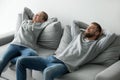 Happy couple relaxing taking nap on cozy sofa at home Royalty Free Stock Photo