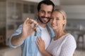 Happy millennial couple showing key from new house Royalty Free Stock Photo