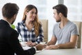 Happy millennial couple visiting realtor buying first home