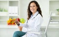 Happy millennial european woman doctor nutritionist in white coat Royalty Free Stock Photo