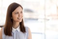 Happy millennial female employee look in distance dreaming Royalty Free Stock Photo