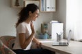 Happy millennial female making video call by laptop using webcam Royalty Free Stock Photo