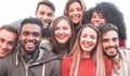 Happy millennial friends from diverse cultures and races taking selfie for social network story - Youth and friendship concept