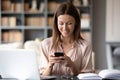 Happy young woman distracted from work using cellphone Royalty Free Stock Photo