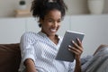 Happy millennial girl, young Black woman reading book Royalty Free Stock Photo