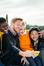 Happy millennial group of multiracial people taking selfie together outdoors Royalty Free Stock Photo