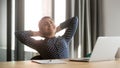 Happy indian woman relax in office chair finishing work Royalty Free Stock Photo