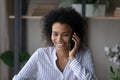 Smiling African American woman talk on smartphone call Royalty Free Stock Photo