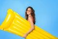 Happy millennial mixed race lady in swimsuit and sunglasses hold inflatable mattress Royalty Free Stock Photo