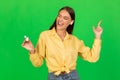 Happy Millennial Woman With Earbuds Earphones Listening Music, Green Background