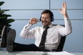 Happy millennial worker listen to music in headphones in office Royalty Free Stock Photo