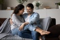 Happy millennial young couple dating at home, relaxing on couch Royalty Free Stock Photo
