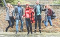 Happy millennials friends jumping outdoor celebrating together - Young students people having fun laughing and smiling - Youth, Royalty Free Stock Photo