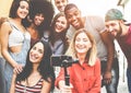 Happy millennials friends making video vlog with smartphone outdoor - Young people having fun with new technology trends - Youth