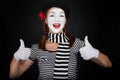 Happy mime comedian showing thumbs up