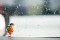 Happy miniature girl piggybacking adorable little sister against rain water drops background