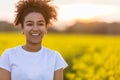 Happy Mixed Race African American Teenager Woman in Yellow Flowers Royalty Free Stock Photo