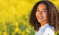 Happy Mixed Race African American Teenager Woman in Yellow Flowers Royalty Free Stock Photo