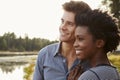 Happy mixed race couple admiring a view in the countryside