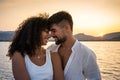 Happy mixed race couple, Caucasian attractive bearded man with her cute Hispanic girlfriend, smiling face to face looking each