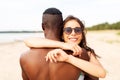 Happy mixed race couple hugging on summer beach Royalty Free Stock Photo