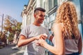 Mixed race couple in love listening to the music on phone and dancing on city street using earphones. Royalty Free Stock Photo