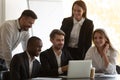 Happy mixed race employees looking at computer screen. Royalty Free Stock Photo