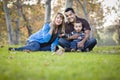 Happy Mixed Race Ethnic Family Playing with Bubbles In The Park Royalty Free Stock Photo