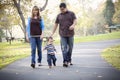 Happy Mixed Race Ethnic Family Walking