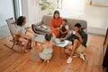 A happy mixed race family of five relaxing in the lounge and being playful together. Loving black family bonding with Royalty Free Stock Photo