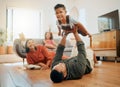 A happy mixed race family of five relaxing in the lounge and being playful together. Loving black family bonding with Royalty Free Stock Photo