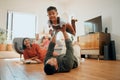 A happy mixed race family of five relaxing in the lounge and being playful together. Loving black family bonding with Royalty Free Stock Photo