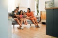 A happy mixed race family of five relaxing on the sofa at home. Loving black family being affectionate on the sofa while