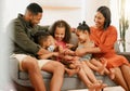 A happy mixed race family of five relaxing on the sofa at home. Loving black family being playful on the sofa. Young