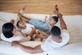 Happy mixed race family of four relaxing on the couch together in the lounge at home. Cheerful brother and sister Royalty Free Stock Photo