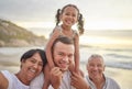 Happy mixed race family of four walking on the beach. A cute girl enjoying the sand and sea with their dad, grandfather Royalty Free Stock Photo